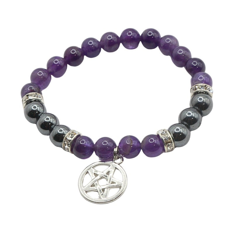 Beaded bracelet with purple and black beads and a silver pentagram charm on a white background