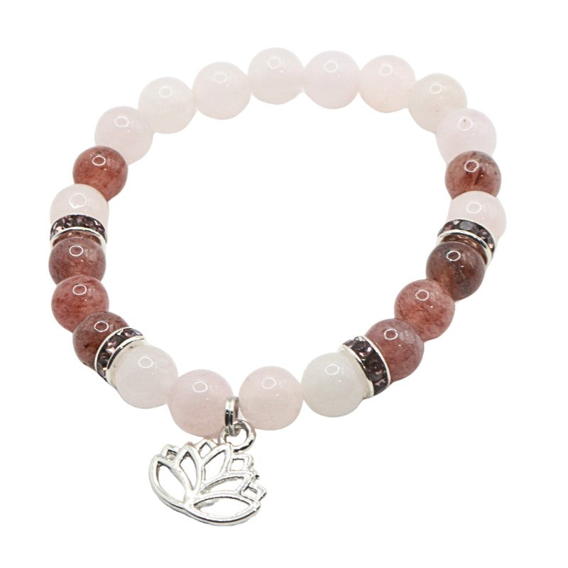 Beaded bracelet with pink and brown stones and a silver lotus charm on a white background