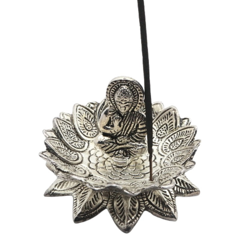 incense stick on a lotus shaped aluminium incense burner with a buddha in the centre