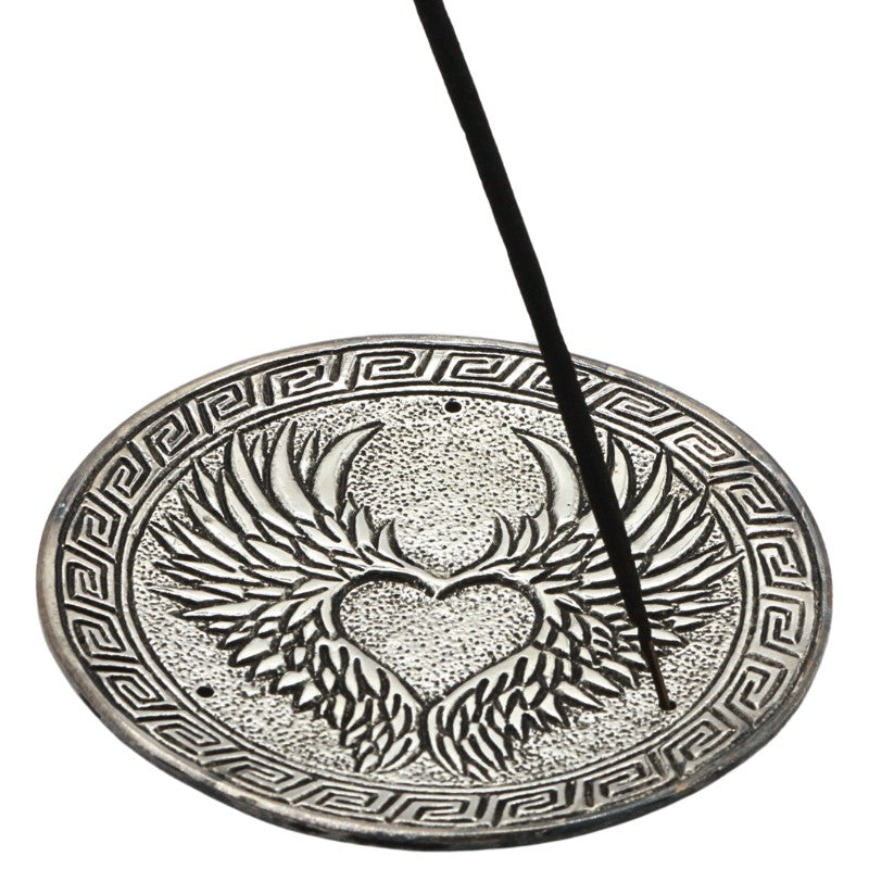 incense stick in an aluminium incense burner with angel wings in a heart pattern
