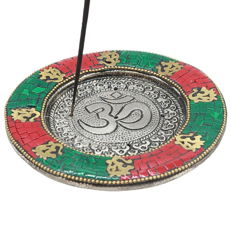 incense stick in a red, green and gold om incense plate