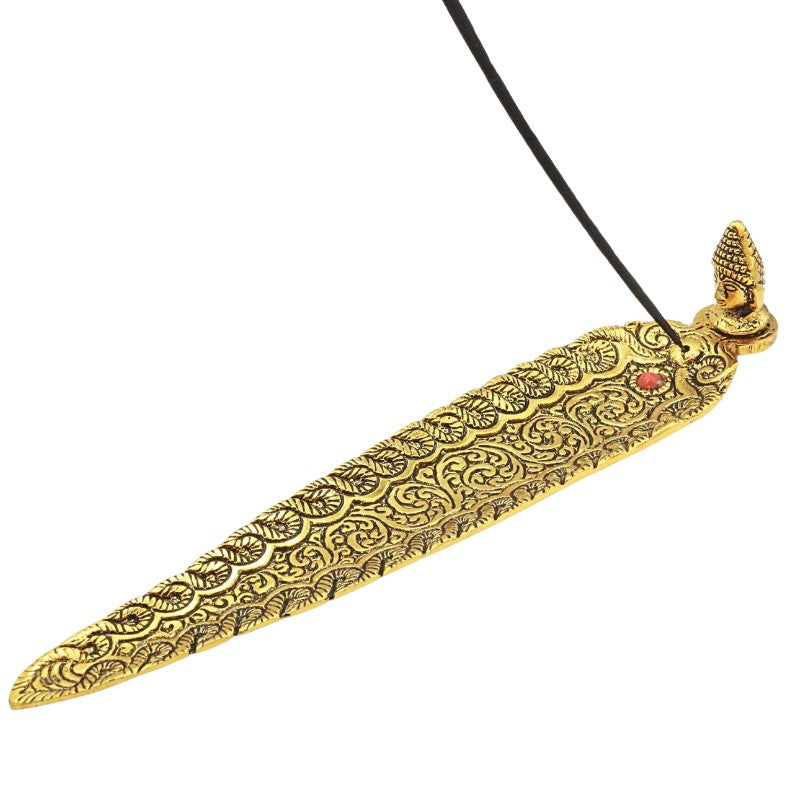 incense stick in a Gold aluminium incense holder with buddha head
