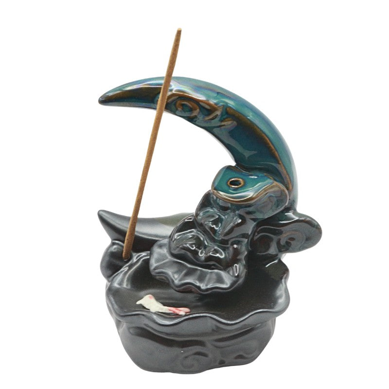 Ceramic incense burner shaped like a crescent moon on a white background.
