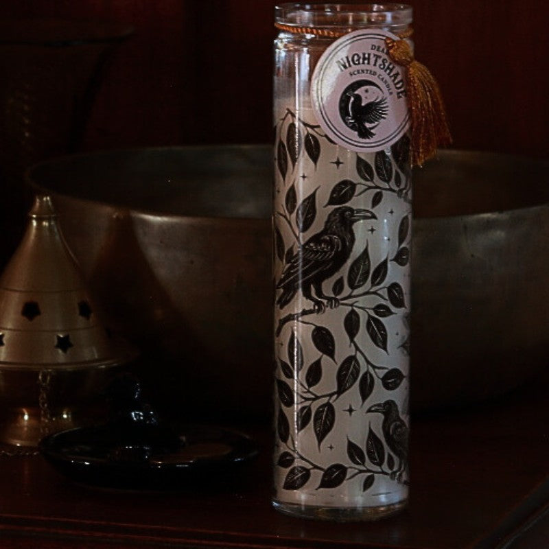 Glass bottle with decorative label featuring a bird design on a dark background
