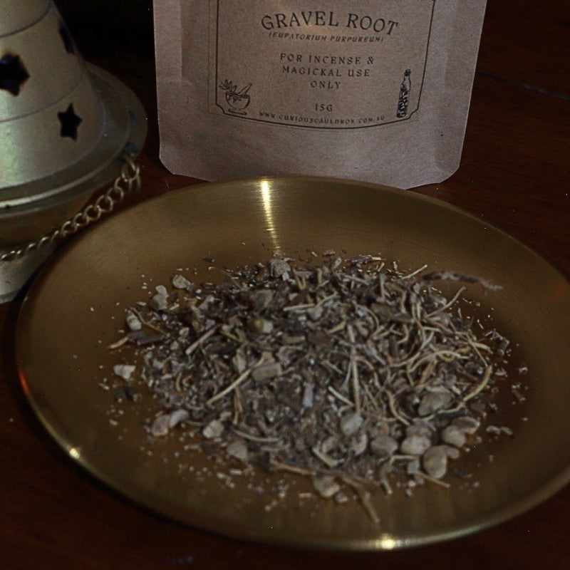 Gravel root incense on a gold plate with a labeled package in the background