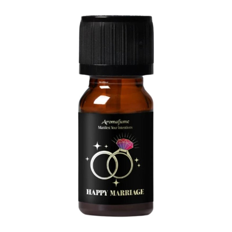 A small amber glass bottle with a black cap and a black label reading 'Aromafume' and 'HAPPY MARRIAGE,' featuring a ring graphic with a pink gem, on a plain white background.