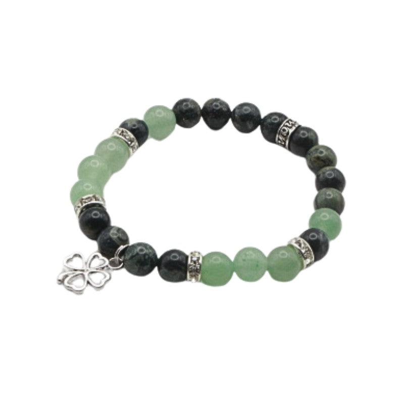 Bracelet with green and black beads on a white background