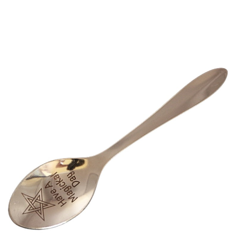 stainless steel teaspoon with "have a magickal day" and a pentagram engraved in the dish