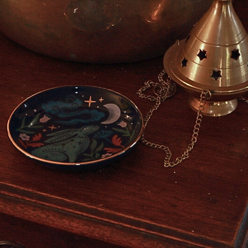 Midnight Hare Trinket Dish on an altar table next to a brass charcoal burner and singing bowl
