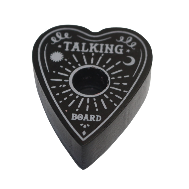Black spell candle holder shaped as a Ouija board planchette