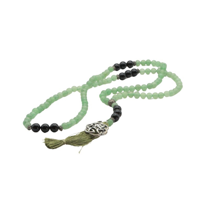 Mala necklace with green and black beads on a white background