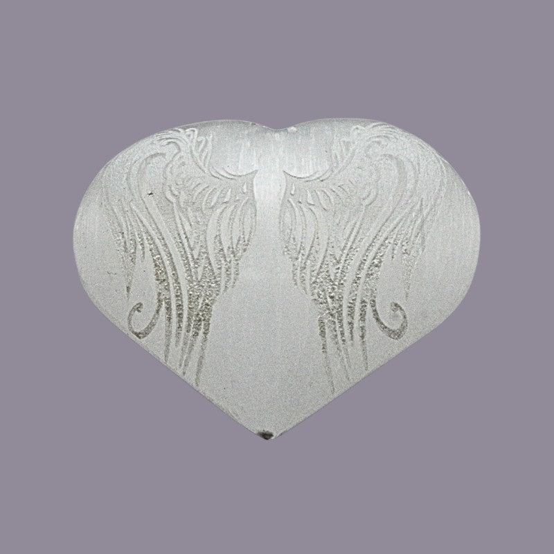 Heart-shaped object with angel wings patterns on a purple background