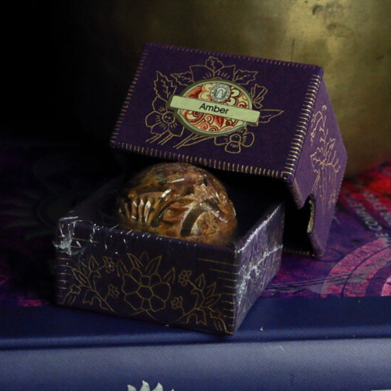 Song Of India Natural Solid Perfume- Amber in front of singing bowl