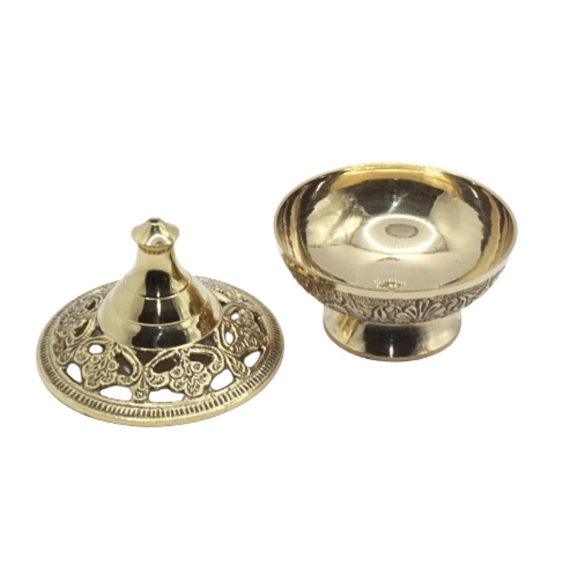 Two parts of a gold-coloured incense burner on a white background