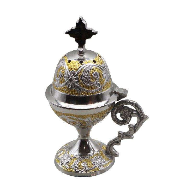 Decorative metal incense burner with intricate designs on a white background