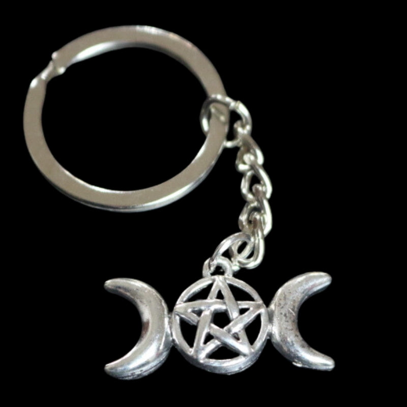 silver coloured key ring with a triple moon (a crescent moon on either side of a circle) with a pentagram inside the circle (5 pointed star within a circle) joined to a silver ring by a silver chain