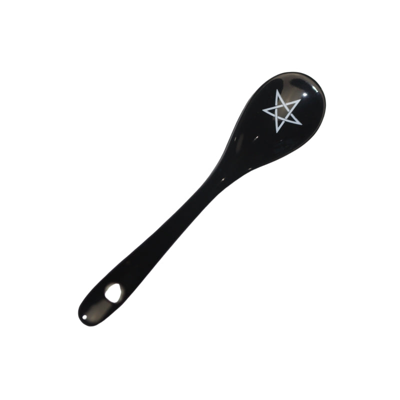 black spoon decorated with a white pentacle.