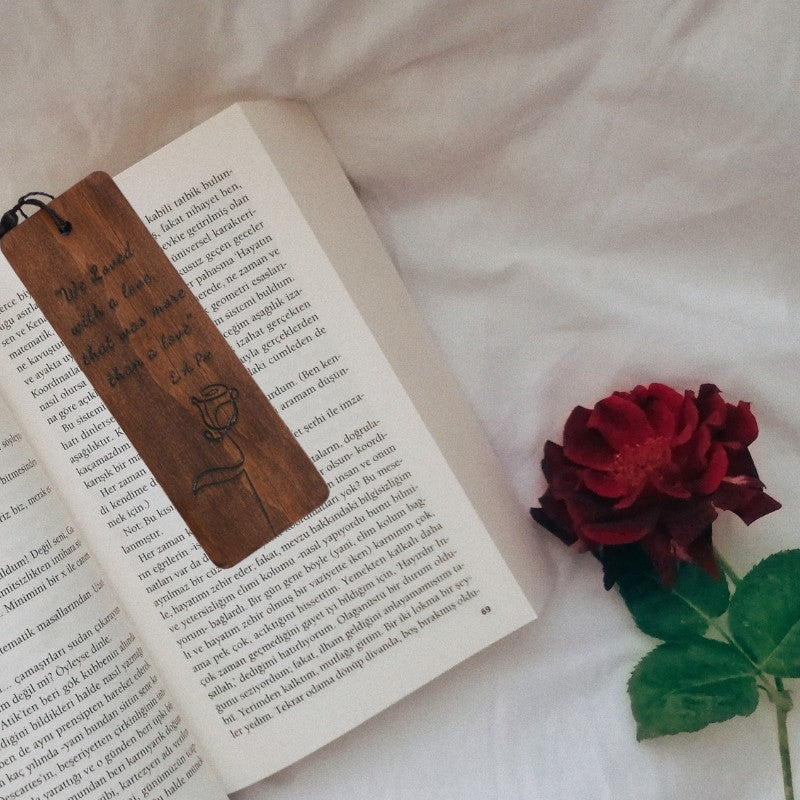 handmade bookmark on an open book with a red rose