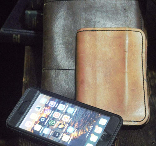 graphic journal in leather cover a written journal in leather cover and an iPhone as a digital journal.