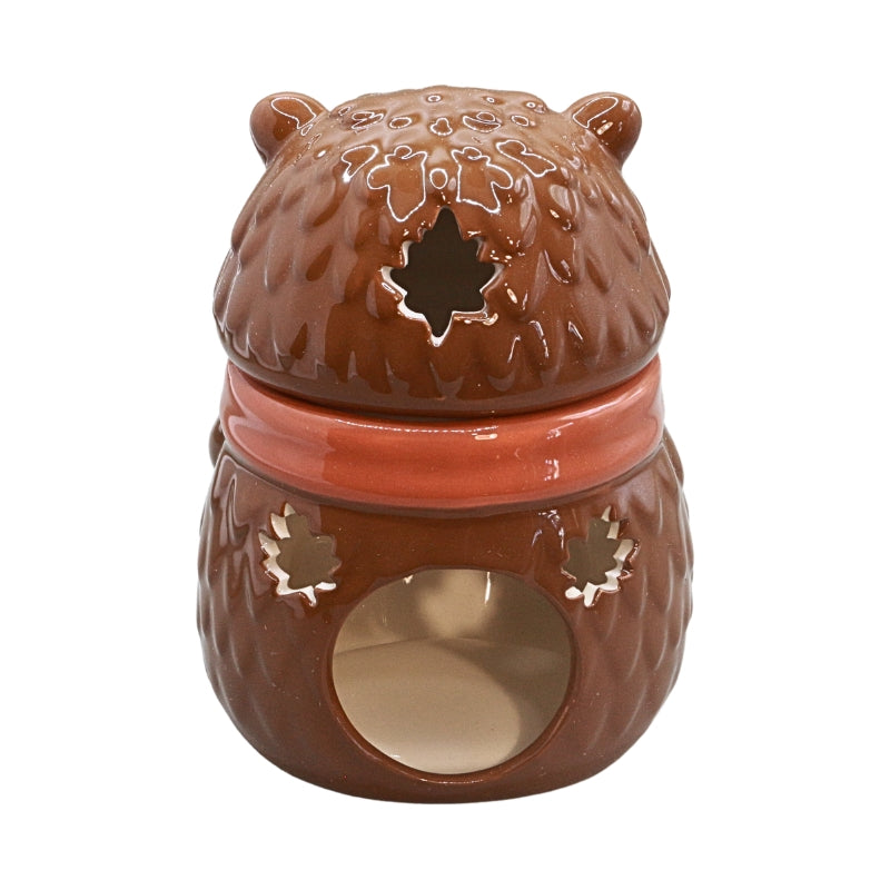 A brown ceramic bear-shaped wax warmer with a textured fur-like pattern, a star-shaped cutout on the lid, and a circular opening at the bottom, shown on a plain white background.