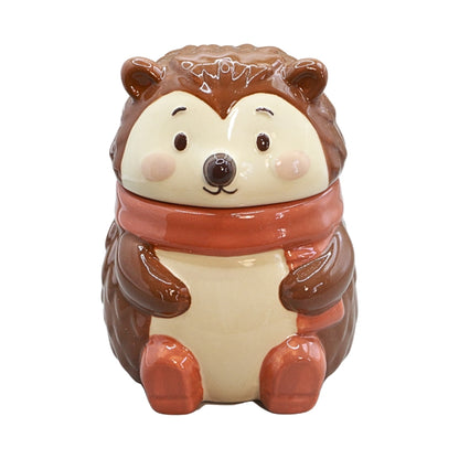 A ceramic incense burner shaped like a cute hedgehog wearing a warm orange scarf, set against a plain white background.