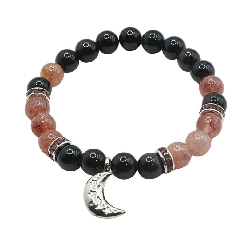 Beaded bracelet with black and pink beads and a silver moon charm on a white background