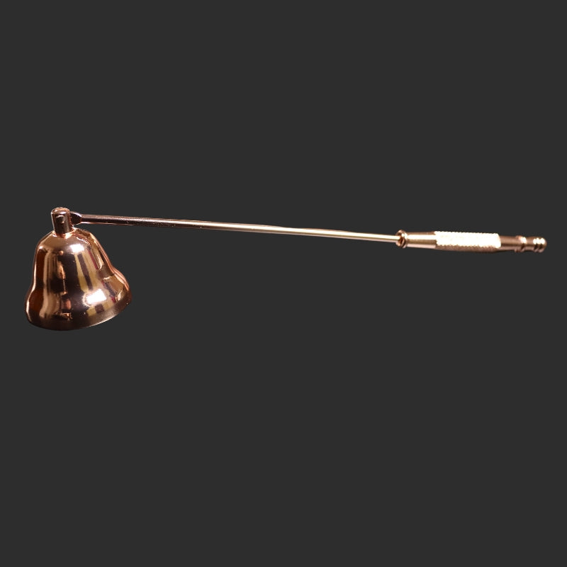 rose gold coloured candle snuffer on a dark grey background