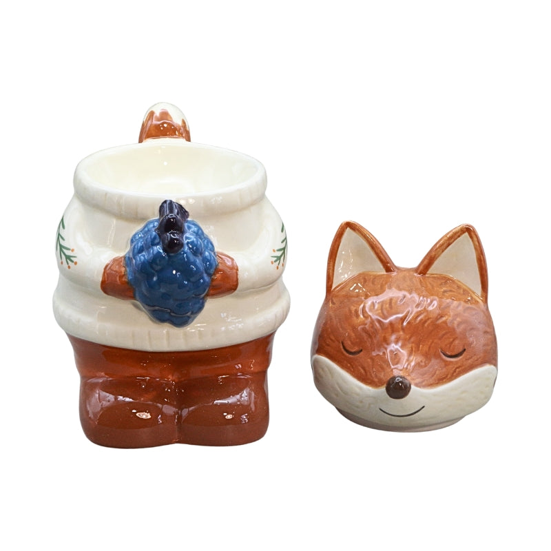 A ceramic oil burner featuring a fox head and a fox body  figure with a blue berries detail, on a plain white background.