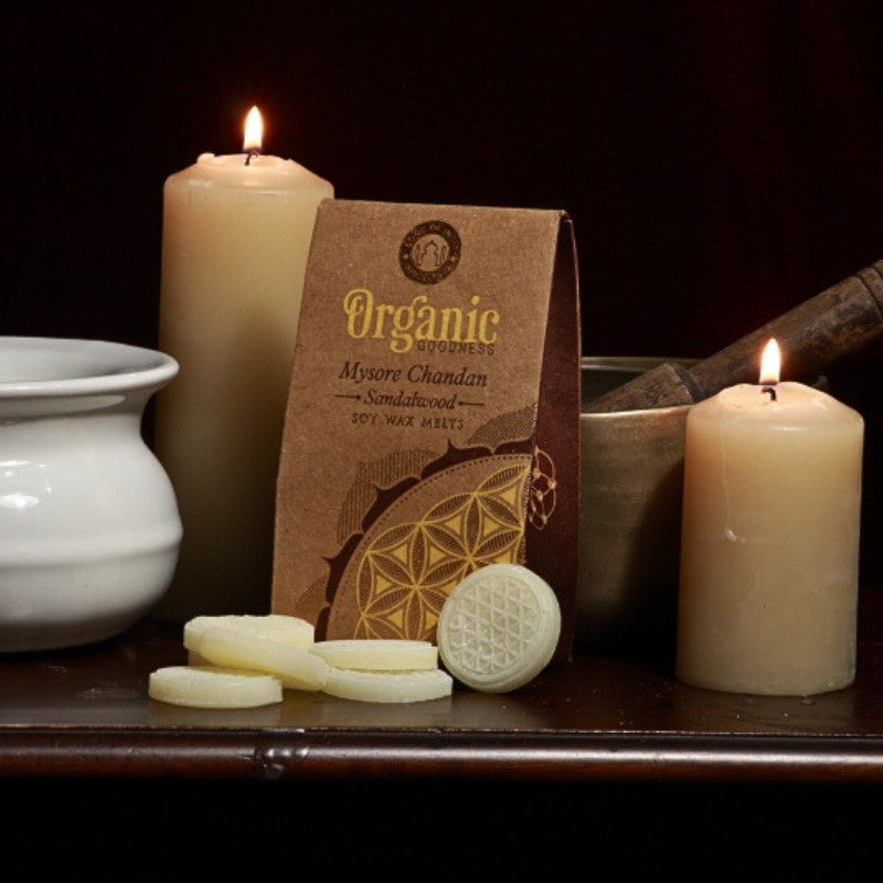 pack of organic goodness wax melts, wax melts in front of a singing bowl, beeswax candles and oil burner