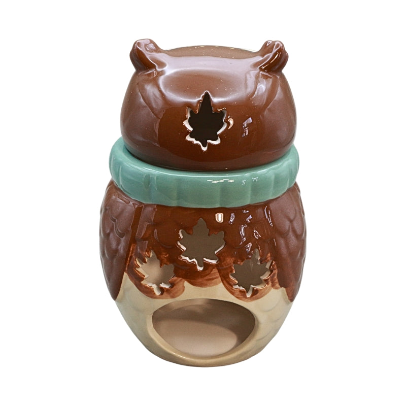 An owl-shaped ceramic oil burner with a brown body, a mint green band around the middle, and a beige base, featuring leaf-shaped cutouts.