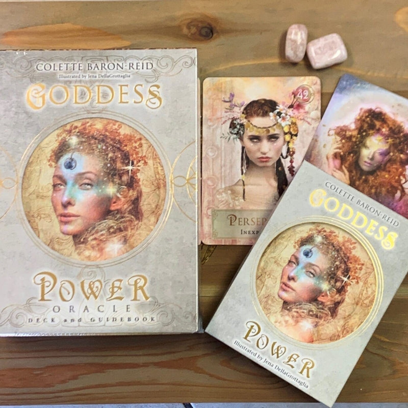 Goddess Power Oracle Cards on wooden table with tumbled stones