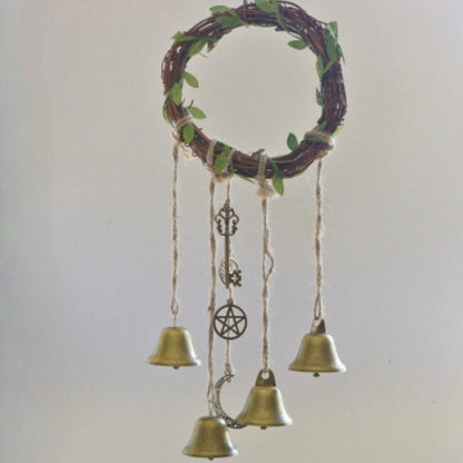 twig wreath with 4 gold bells and charms hanging from it