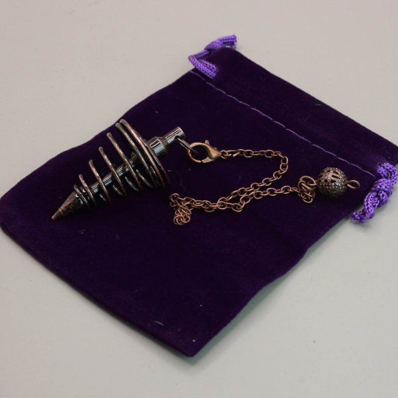 antique copper spiral pendulum  on purple velvet pouch