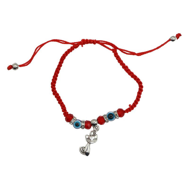 braided red bracelet with 2 blue and white eye shaped beads and a silver cat charm in the centre