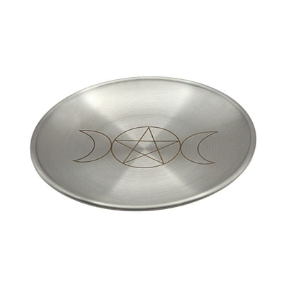 Metallic dish with pentagram and moon phase design on a white background
