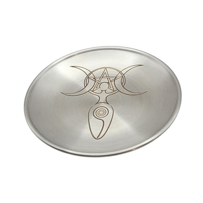 Metallic dish with engraved goddess symbol on a white background