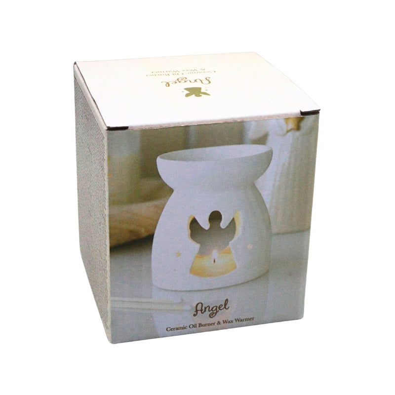 A white ceramic angel-shaped oil burner and wax warmer shown inside its retail box. The box features a photo of the lit product with a glowing yellow interior and gold 'Angel' branding.