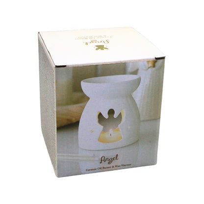 A white ceramic angel-shaped oil burner and wax warmer shown inside its retail box. The box features a photo of the lit product with a glowing yellow interior and gold 'Angel' branding.