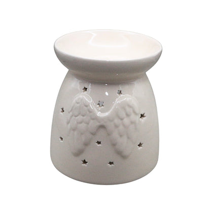 A white ceramic oil burner with a relief of angel wings and small star cutouts, shown on a plain white background.