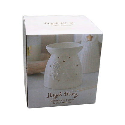 White Angel Wing ceramic oil burner and wax warmer shown in its retail packaging box, featuring an embossed angel design and star cutouts.