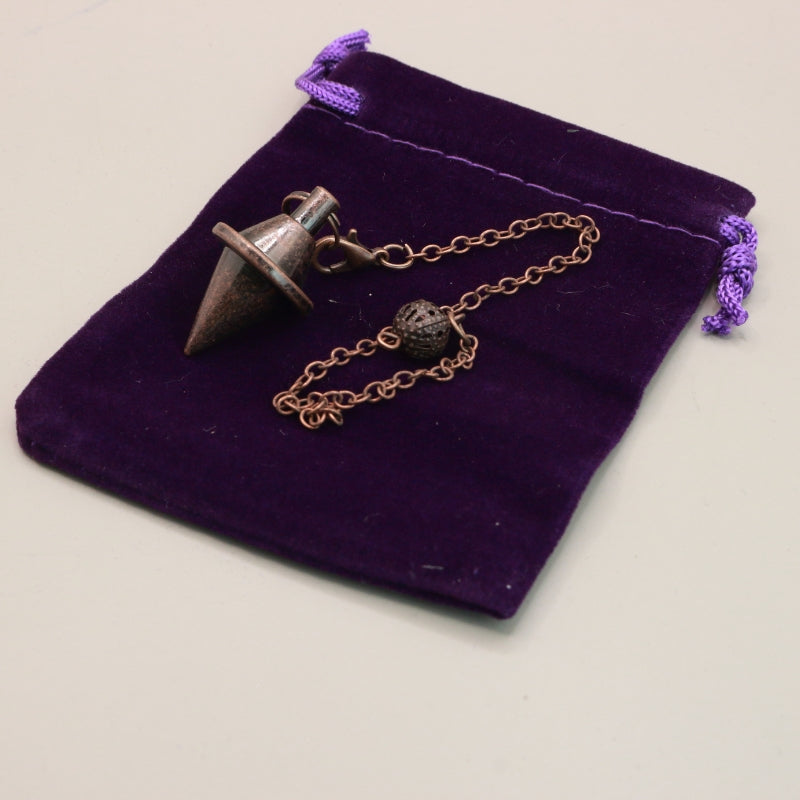 Antique Copper Pendulum on purple velvet bag