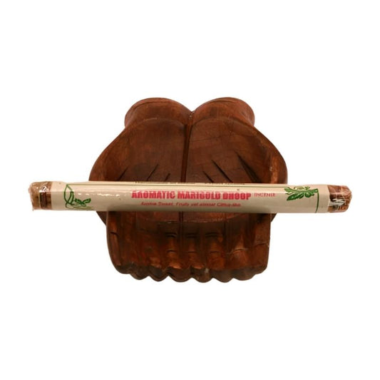 pk of natural tibetan dhoop incense on a pair of open wooden carved hands