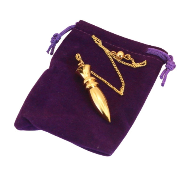 Brass pendulum on purple velvet pouch