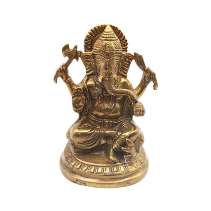 Brass statue of a seated deity with a white background