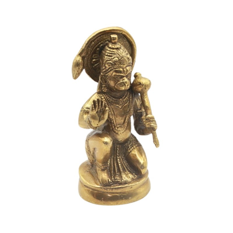 Brass figurine of a seated deity on a white background