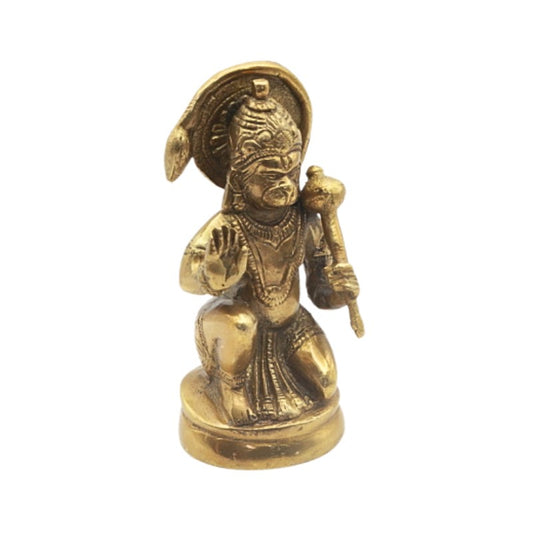 Brass figurine of a seated deity on a white background