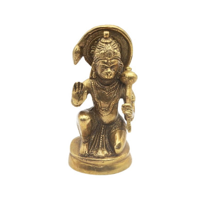 Gold-colored statue of a seated figure on a white background