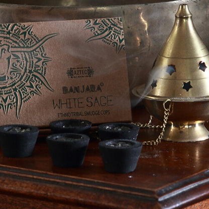 Banjara Smudge cups next to a brass thurible on a wooden table