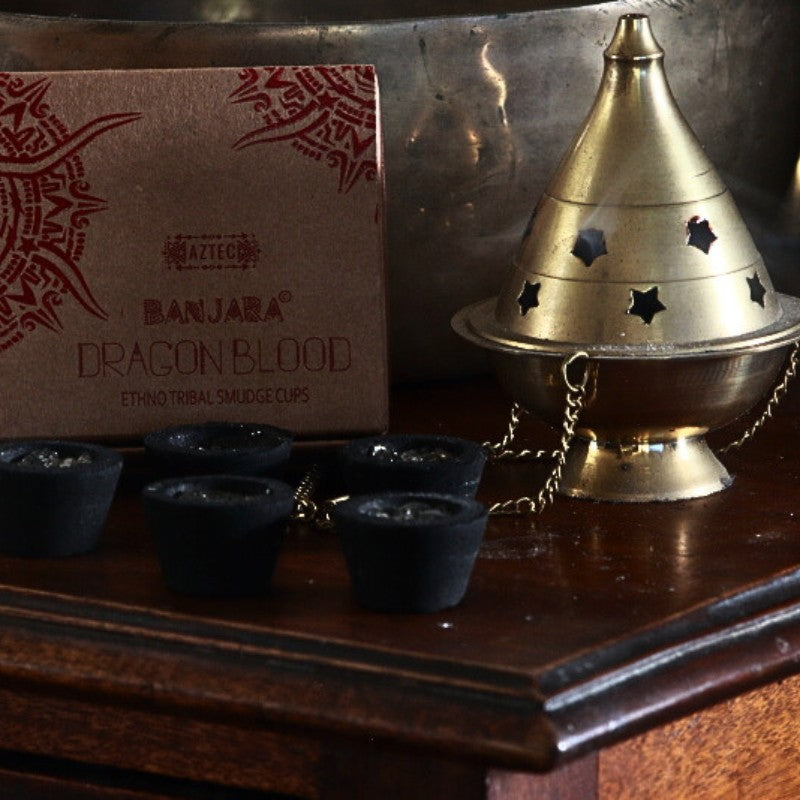 Banjara Smudge cups next to a brass thurible on a wooden table