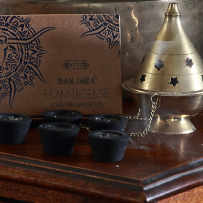 Banjara Smudge cups next to a brass thurible on a wooden table